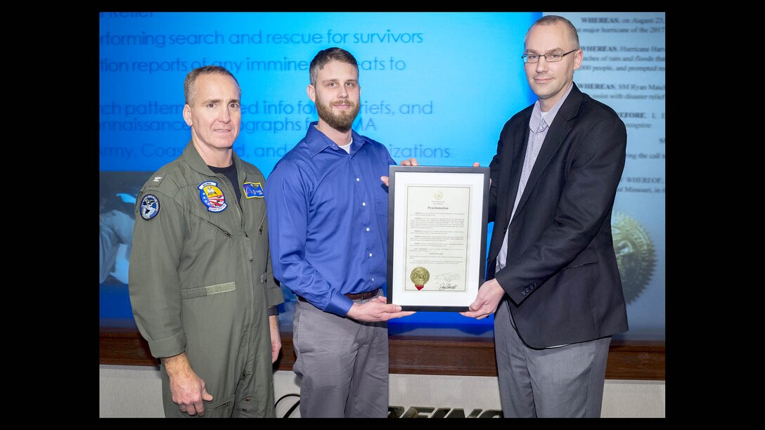 Defense Contract Management Agency Boeing St. Louis Commander Navy Capt. Paul Filardi and his Quality Assurance Director Steve Santel present Quality Assurance Specialist Ryan Maichel (center) with a commendation signed by Missouri Gov. Eric Greitens “for his selfless actions in performing search and rescue operations and disaster relief in response to Hurricane Harvey.” (Photo courtesy of DCMA Boeing St. Louis)