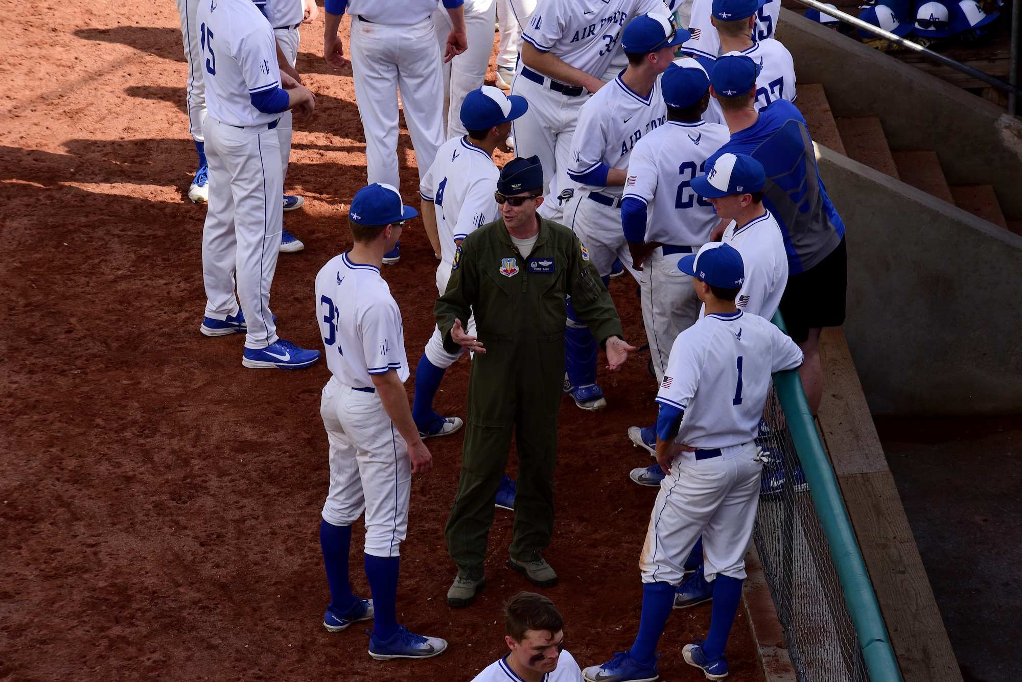 Col. Christopher Sage, 4th Fighter Wing commander, talks with players from the Air Force Falcons before game two against the Navy Midshipmen during the 2018 Freedom Classic, Feb. 24, 2018, at Grainger Stadium in Kinston, North Carolina. Navy won game two of the three-game series 6-4. (U.S. Air Force photo by Airman 1st Class Kenneth Boyton)