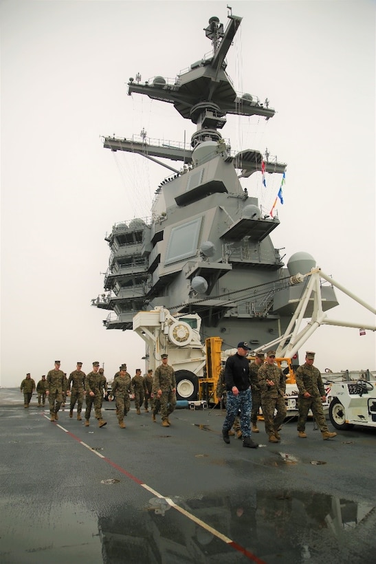 Marines from U.S. Marine Corps Forces Command and Wounded Warrior Detachment Portsmouth, Wounded Warrior Regiment, take a guided tour across the flight deck of the USS Gerald R. Ford at Naval Station Norfolk, Va., Feb. 23. Marines toured the flight deck to gain an understanding of basic operations of how aircraft are safely launched and landed by the ship’s crew and machinery. (Official U.S. Marine Corps photo by Sgt. Mark Tuggle/Released)