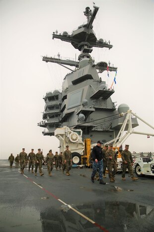 Marines from U.S. Marine Corps Forces Command and Wounded Warrior Detachment Portsmouth, Wounded Warrior Regiment, take a guided tour across the flight deck of the USS Gerald R. Ford at Naval Station Norfolk, Va., Feb. 23. Marines toured the flight deck to gain an understanding of basic operations of how aircraft are safely launched and landed by the ship’s crew and machinery. (Official U.S. Marine Corps photo by Sgt. Mark Tuggle/Released)