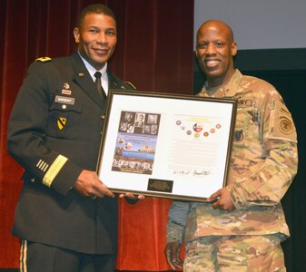 Col. Terance Huston, commander of the 5th Recruiting Brigade and host for the Black History Month observance Feb. 23 at Joint Base San Antonio-Fort Sam Houston, presents a framed gift to Maj. Gen. Patrick D. Sargent, deputy commanding general for operations, U.S. Army Medical Command, and the 18th Chief of the U.S. Army Medical Service Corps, and guest speaker for the observance.