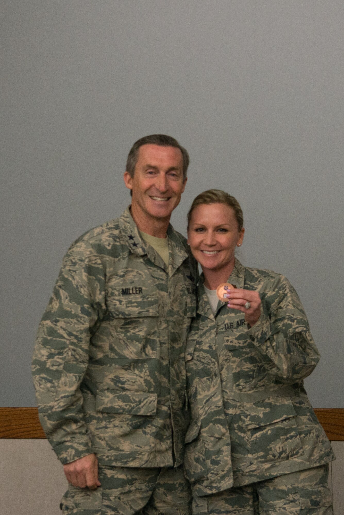 Maj. Sabrina Ura received a coin from Tenth Air Force Commander, Maj. Gen. Ronald B. “Bruce” Miller in recognition of her contribution to the conference.