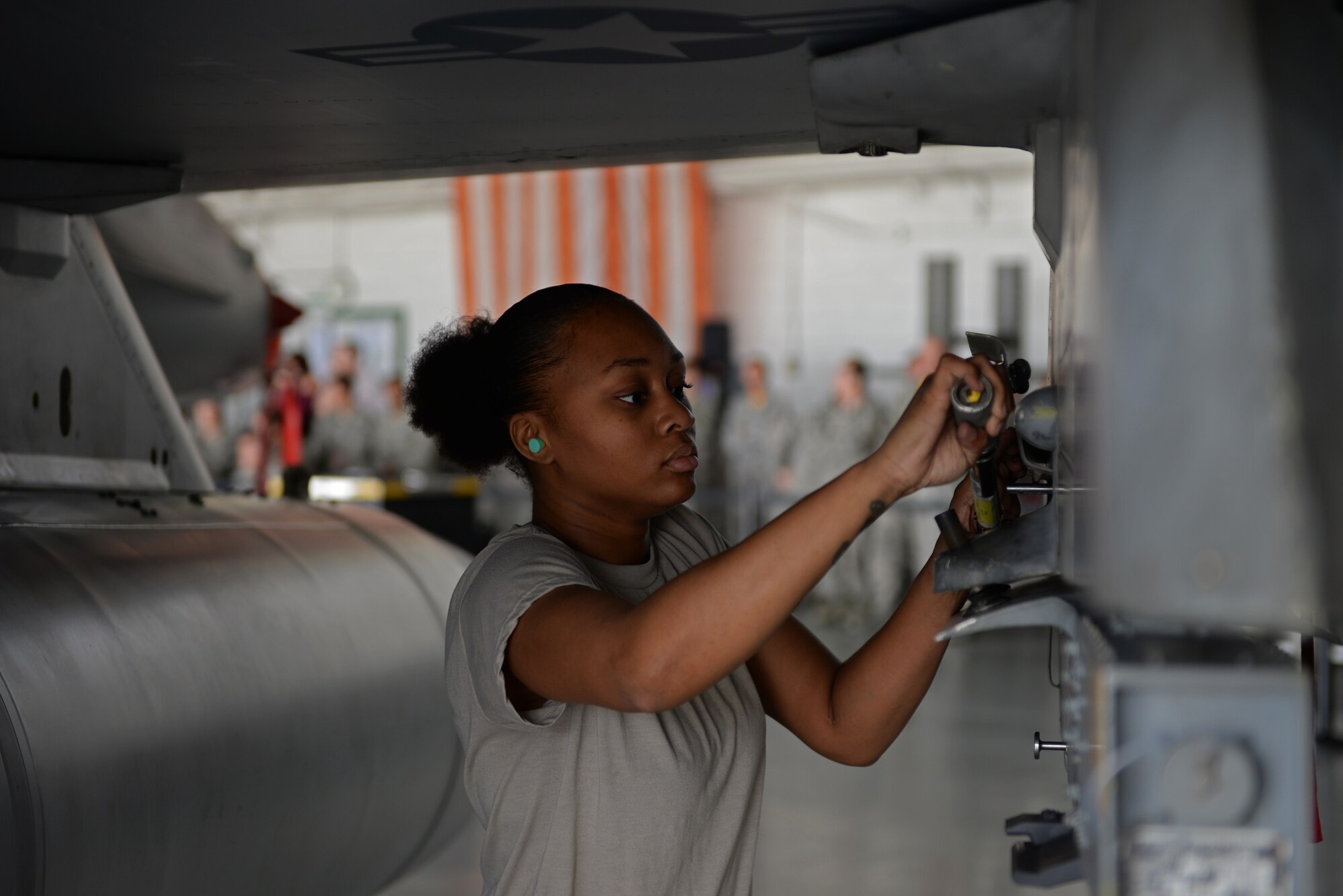 U.S. Air Force Airman 1st Class Rashida Cutts, 79th Aircraft Maintenance Squadron load crew member, prepares the F-16CM Fighting Falcon to load a missile at Shaw Air Force Base, S.C., Feb. 23, 2018.