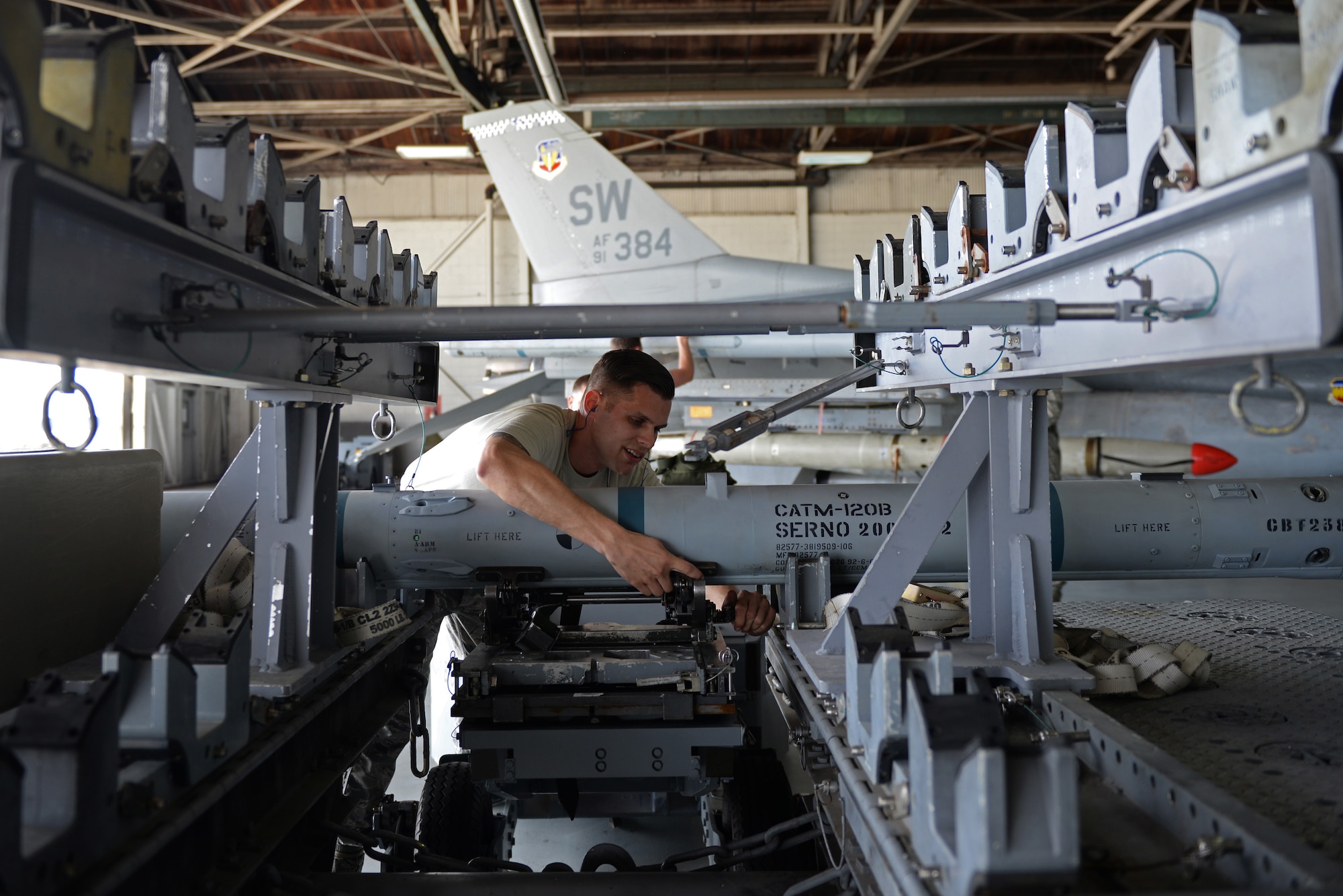 U.S. Air Force Senior Airman Christopher Whitten, 55th Aircraft Maintenance Squadron load crew member, begins to prepare an Air Integrated Missile 120 for loading at Shaw Air Force Base, S.C., Feb. 23, 2018.
