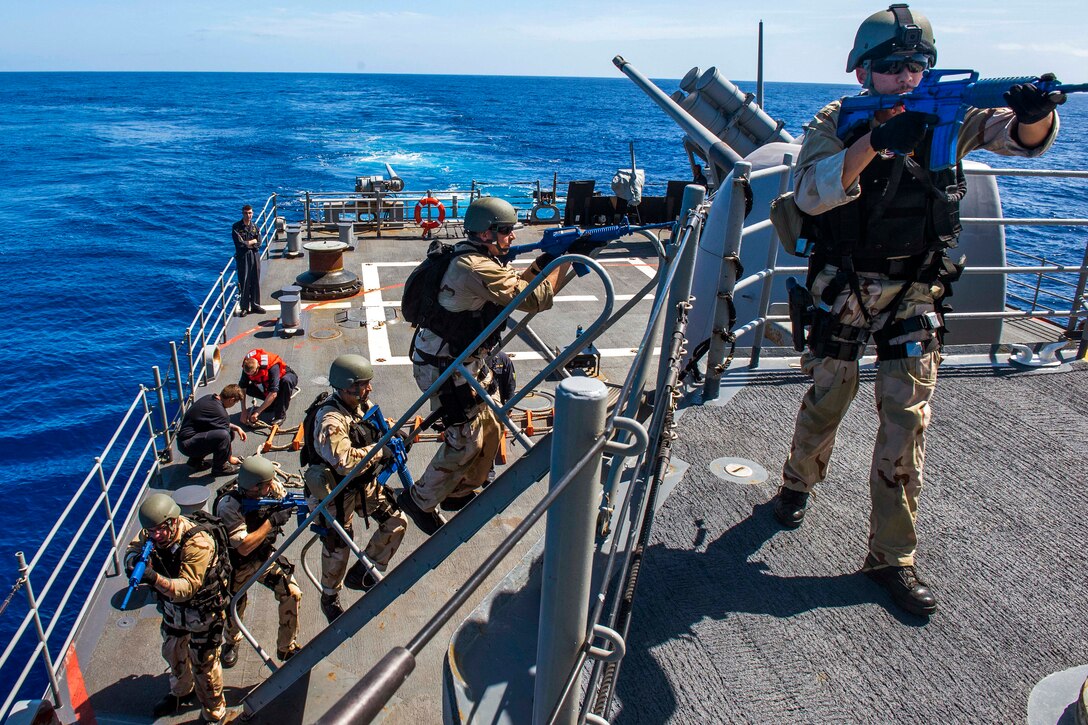 Sailors board Ticonderoga-class guided-missile cruiser USS Lake Champlain during a visit, board, search and seizure drill.