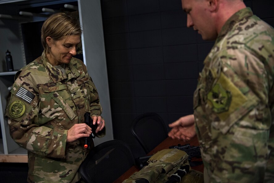 Tech. Sgt. Travis, right, 347th Operations Support Squadron NCO in charge of Survival, Evasion, Resistance and Escape (SERE) training, briefs Col. Jennifer Short, 23d Wing commander, on training tools and techniques during a 347th Rescue Group immersion, Feb. 26, 2018, at Moody Air Force Base, Ga. During the immersion, 23d WG leadership was given an in-depth briefing and demonstration of how SERE specialists and Independent Duty Medical Technicians ensure Moody’s aircrew have the skills to survive in the worst of situations. (U.S. Air Force photo by Senior Airman Daniel Snider)