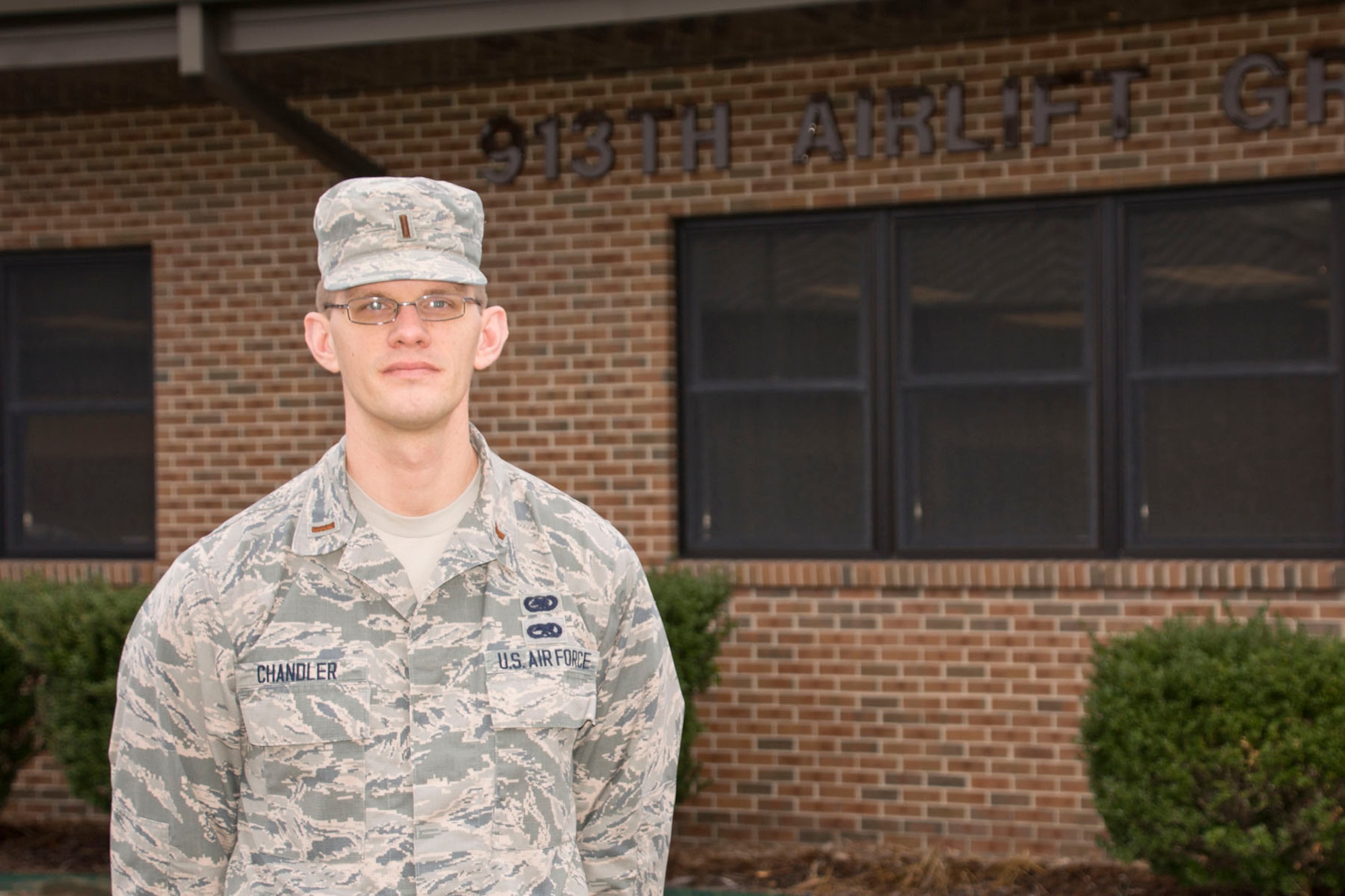 Man in uniform standing in front of his headquarters building.