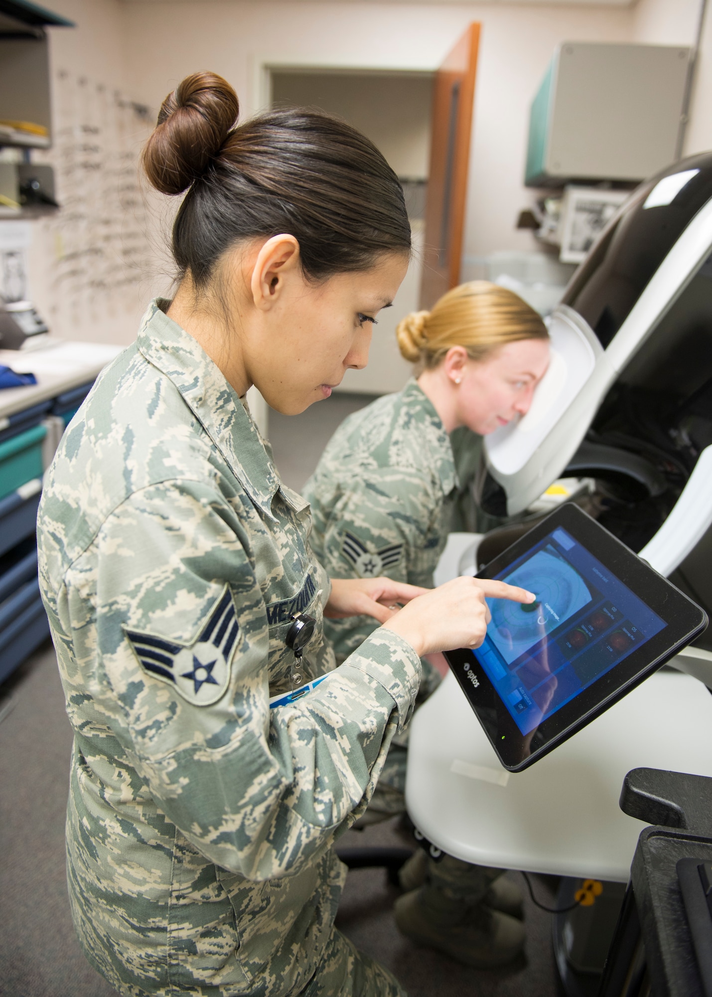 Senior Airman Ashley Amezquita, 673d Aerospace Medicine Squadron optometry technician, takes a retinal photo of Senior Airman Katherine Bant at Joint Base Elmendorf-Richardson, Alaska, Feb. 14, 2018. The Optometry Clinic is responsible for all routine eye appointments as well as eye injuries on a case-by-case basis.
