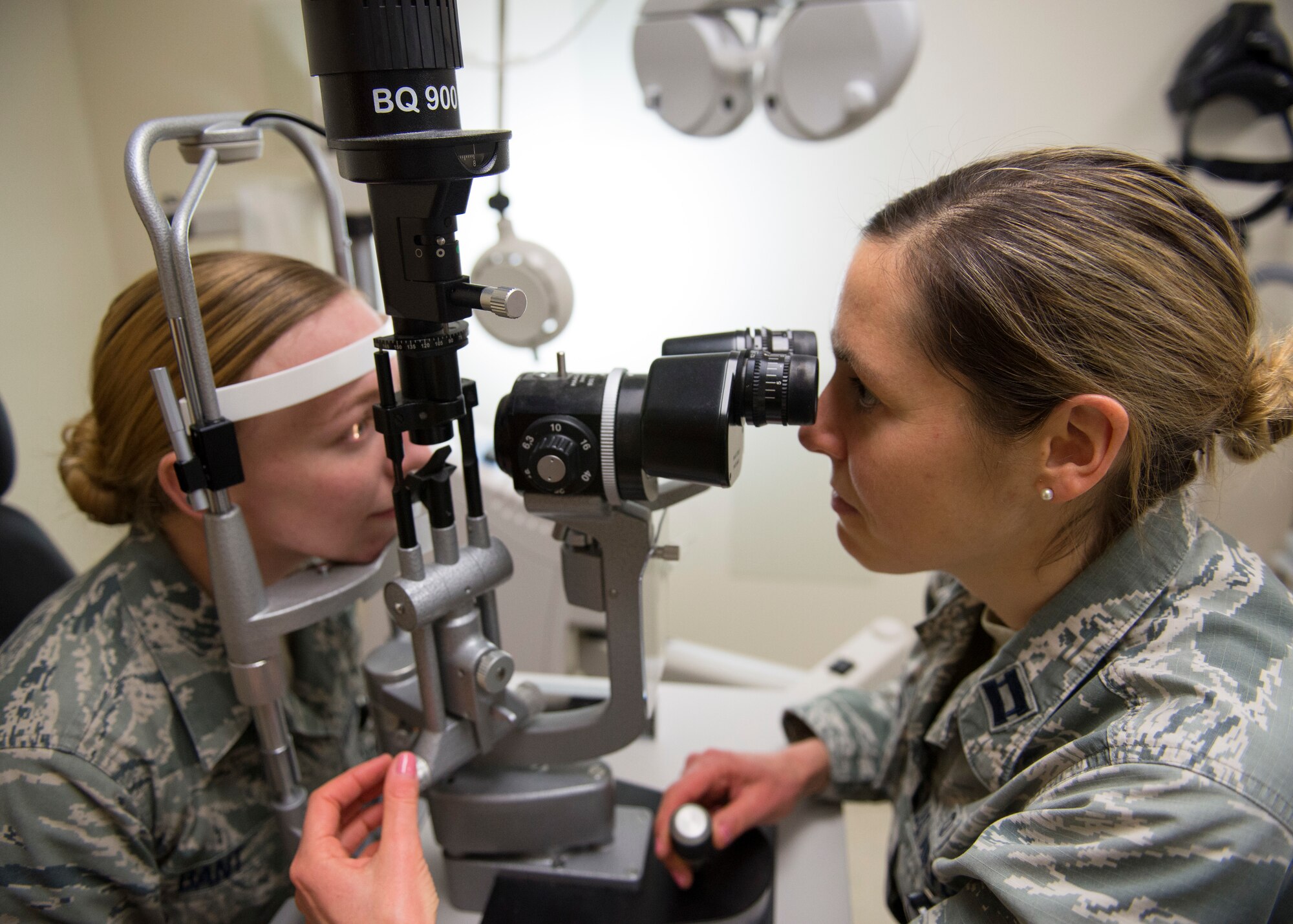 Air Force Capt. Lauren Pfendler, 673d Aerospace Medicine Squadron chief of Aerospace Optometry, performs an eye exam on Senior Airman Katherine Bant, 673d AMS optometry technician at Joint Base Elmendorf-Richardson, Alaska, Feb. 14, 2018. The Optometry Clinic is responsible for all routine eye appointments as well as eye injuries on a case-by-case basis.