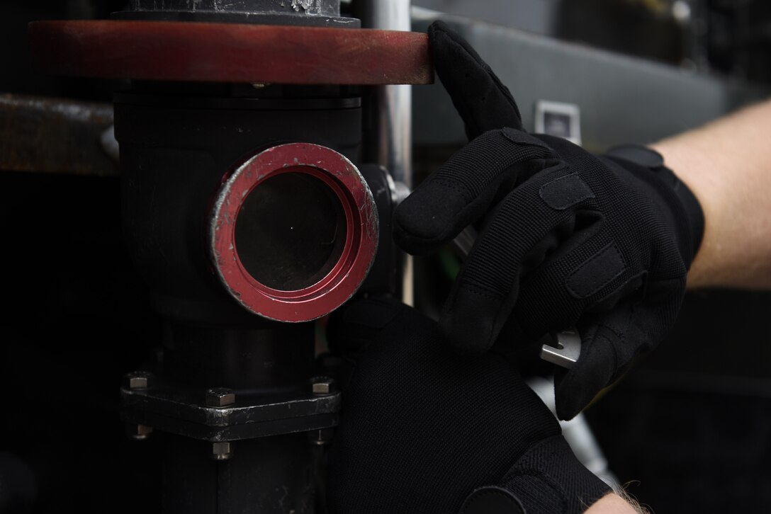 U.S. Air Force Senior Airman Reinhardt Andersen, 20th Logistics Readiness Squadron fuels distribution operator, checks a hose filter at Shaw Air Force Base, S.C., Feb. 22, 2018.