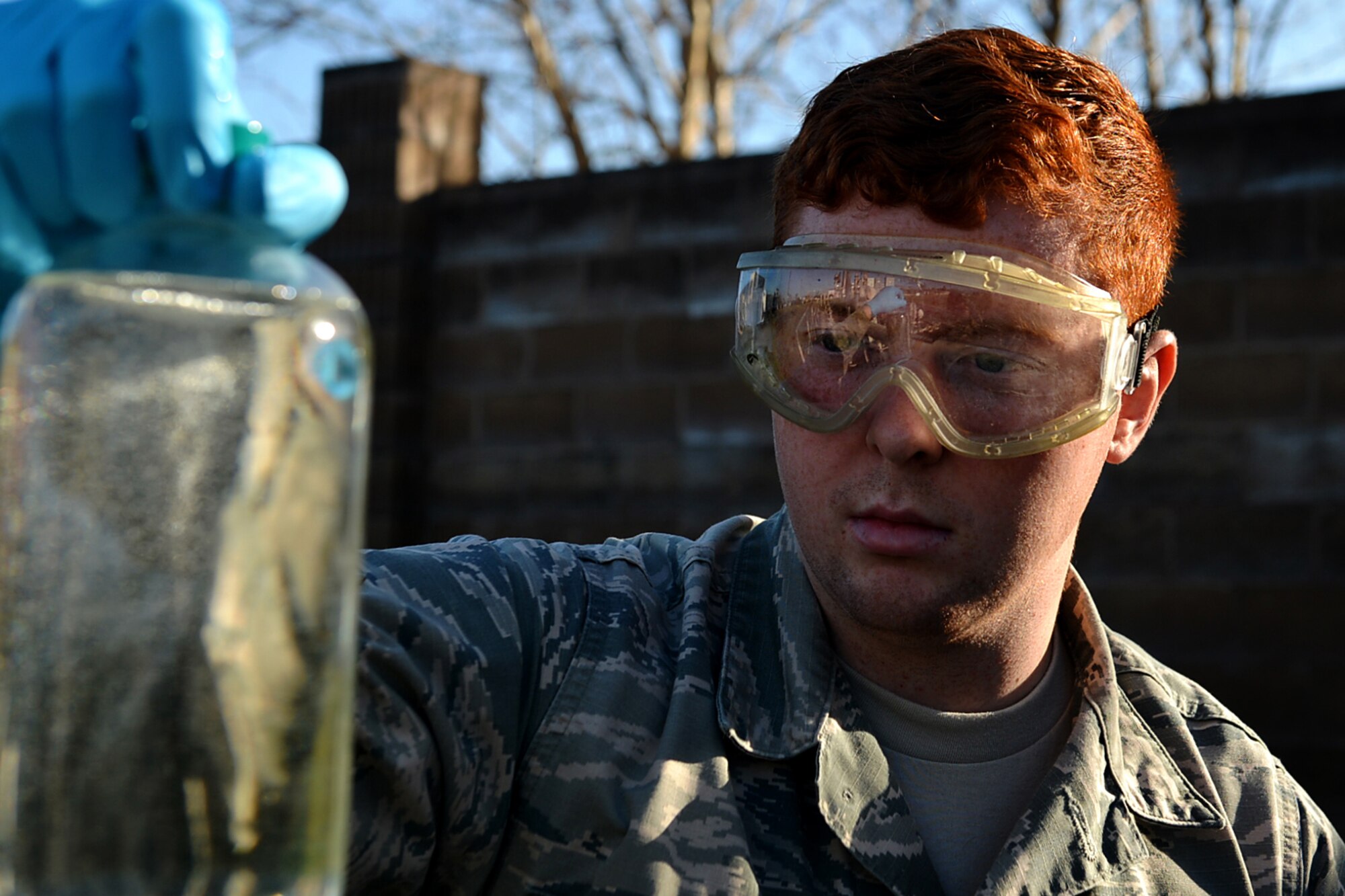U.S. Air Force Airman 1st Class Zachary Hupp, 20th Logistics Readiness Squadron fuels laboratory technician, pulls a fuel sample to take back to the lab for testing at Shaw Air Force Base, S.C., Feb. 23, 2018.