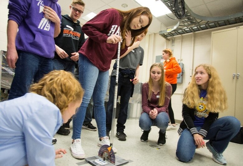 Air Force Institute of Technology Demo Days participants prepare to launch a small rocket, after setting trajectory and power, in a competition for distance and accuracy Feb. 21, 2018 on Wright-Patterson Air Force Base, Ohio. Groups of local high school and middle school students moved among stations being exposed to subjects such as robotics, civil engineering, magnetics and electricity. (U.S. Air Force photo by R.J. Oriez)