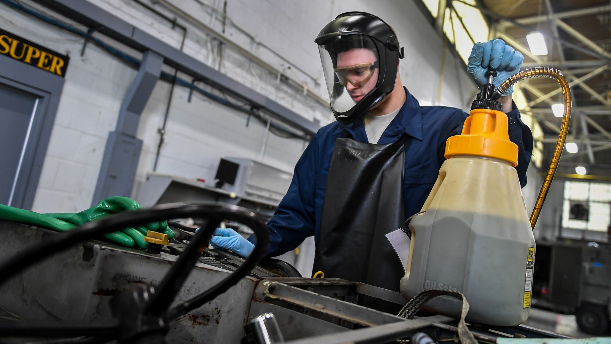 Airman 1st Class Jared Fayard, 2nd Maintenance Squadron aerospace ground equipment technician, adds new motor oil to a bomb loader vehicle at Barksdale Air Force Base, La., Feb. 27, 2018. Fayard changed the engine oil as part of an annual safety inspection conducted on all bomb loading vehicles.