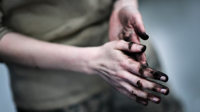 Airman Abigail Weber, 2nd Maintenance Squadron aerospace ground equipment technician, cleans her hands after a bomb loader vehicle tire change at Barksdale Air Force Base, La., Feb. 27, 2018. Proper and timely maintenance of tires is necessary to prevent blow-outs during flight line operations.