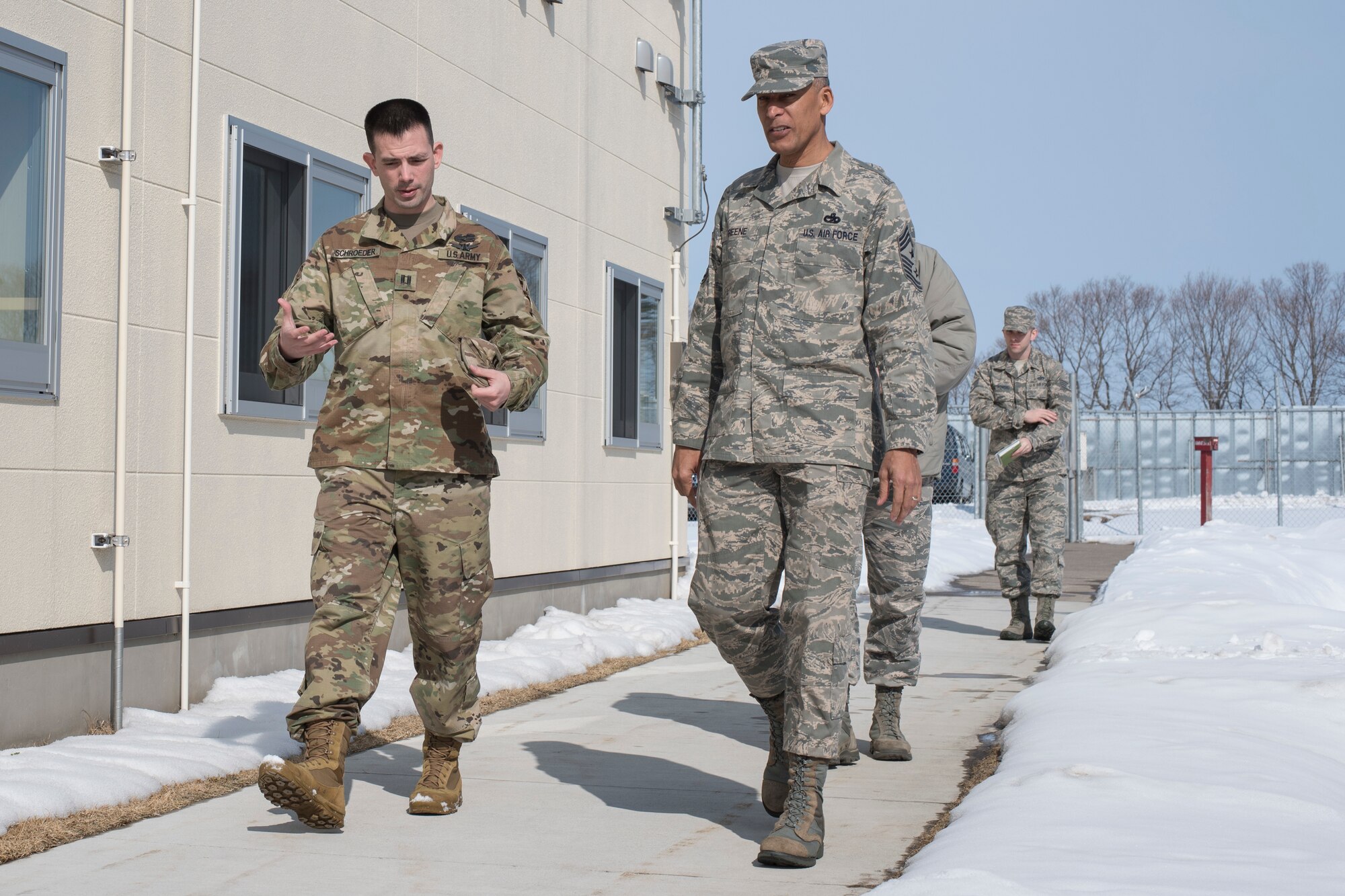 U.S. Army Capt. Lee Schroeder, left, the Delta Detachment, 1st Space Company, Joint Tactic Army Ground Station commander, walks with U.S. Air Force Chief Master Sgt. Terrence A. Greene, right, the United States Forces Japan and Fifth Air Force command chief, during his visit to the JTAGS facility at Misawa Air Base, Japan, Feb. 23, 2018. Greene’s tour included meeting with Team Misawa and Japan Air Self-Defense Force members in order to better understand the capabilities and responsibilities each unit contributes to the “fight tonight” mentality. (U.S. Air Force photo by Airman 1st Class Collette Brooks)