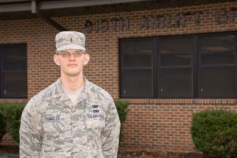 Man in uniform standing in front of his headquarters building.