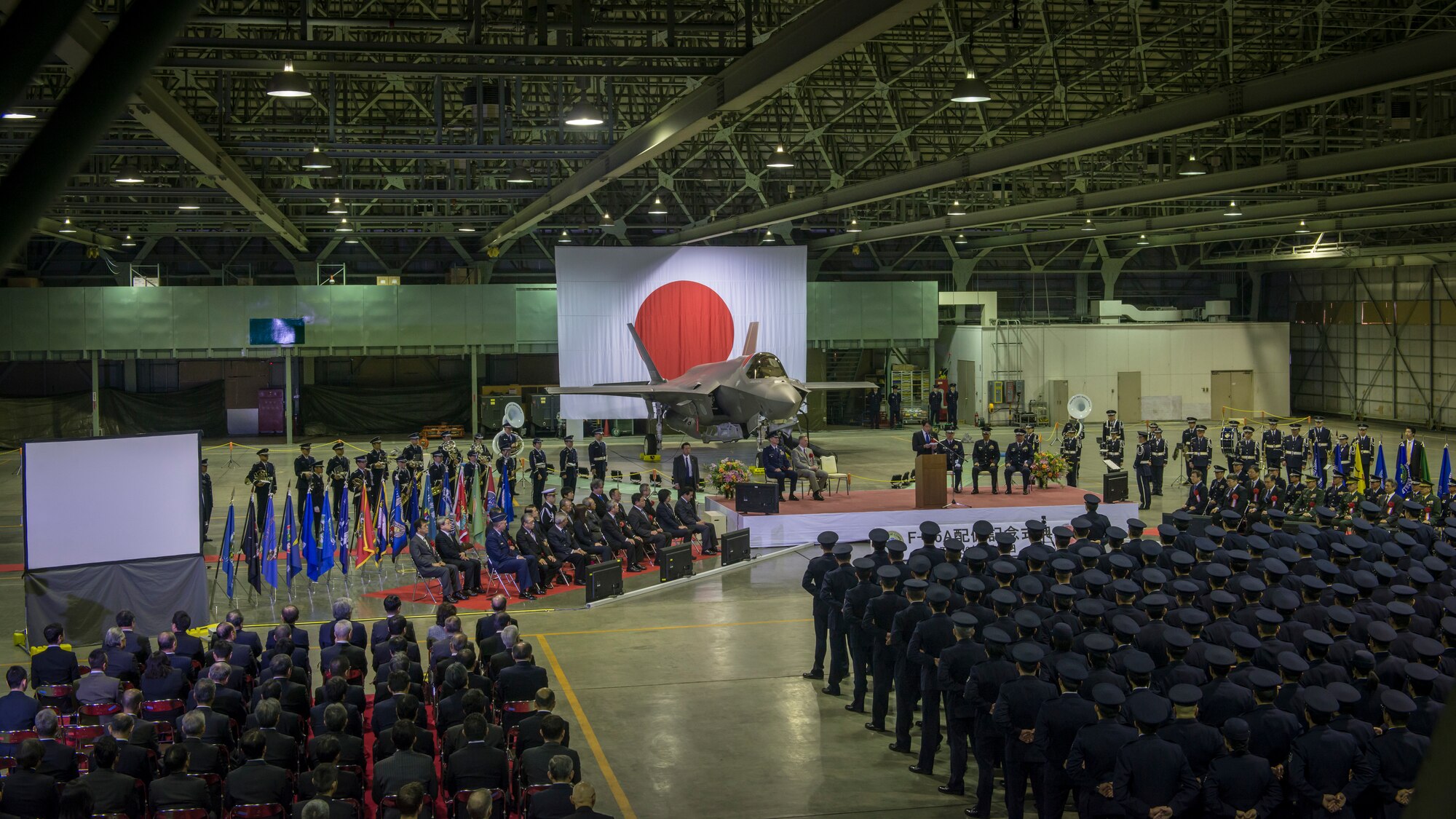 Senior leaders of Japan’s Ministry of Defense, U.S. Forces Japan, Pacific Air Forces and Lockheed Martin gather in a Japan Air Self-Defense Force hangar at Misawa Air Base, Japan, for the commemorative ceremony welcoming the first operational F-35A Lightning II to JASDF's 3rd Air Wing, Feb. 24, 2018. The F-35A is the second assembled at Mitsubishi’s facility in Nagoya, Japan. Regional leaders from Misawa City and Aomori Prefecture also attended the ceremony. (U.S. Air Force photo by Tech. Sgt. Benjamin W. Stratton)
