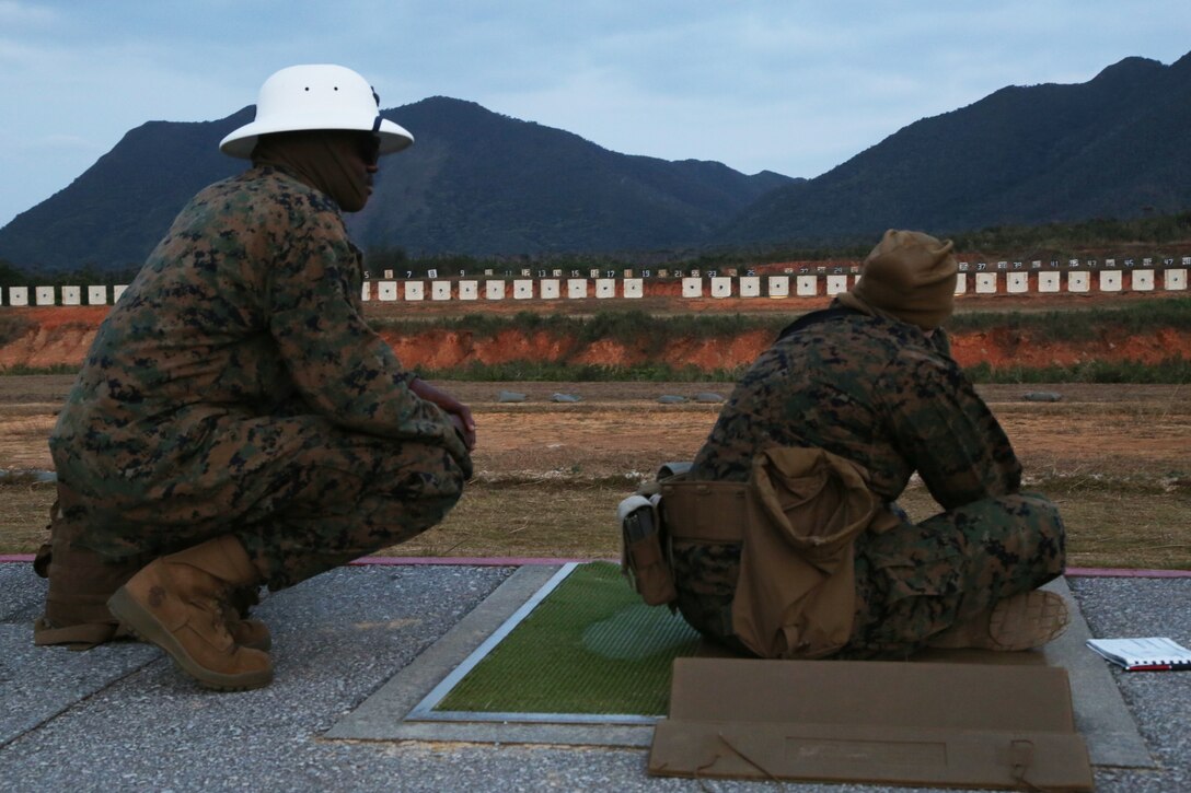 CAMP SCHWAB, OKINAWA, Japan – A range coach watches as a shooter fires on the rifle range Feb. 14 aboard Camp Schwab, Okinawa, Japan.