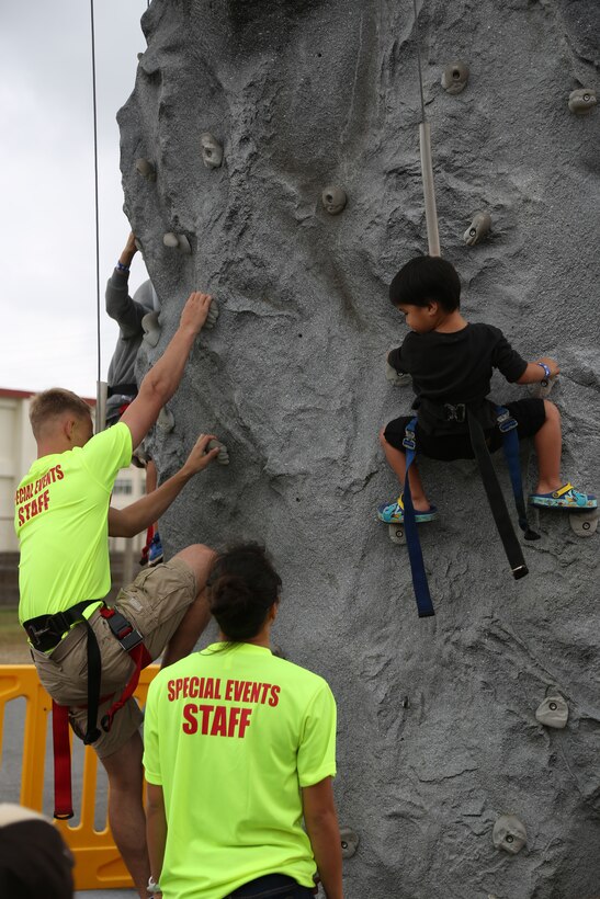 CAMP FOSTER, OKINAWA, Japan – A child climbs the rock wall in the fun land Feb. 25 at the Food Truck Fair aboard Camp Foster, Okinawa, Japan.