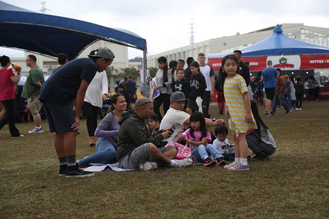 CAMP FOSTER, OKINAWA, Japan – A family sits on the lawn Feb. 25 at the Food Truck Fair aboard Camp Foster, Okinawa, Japan.
