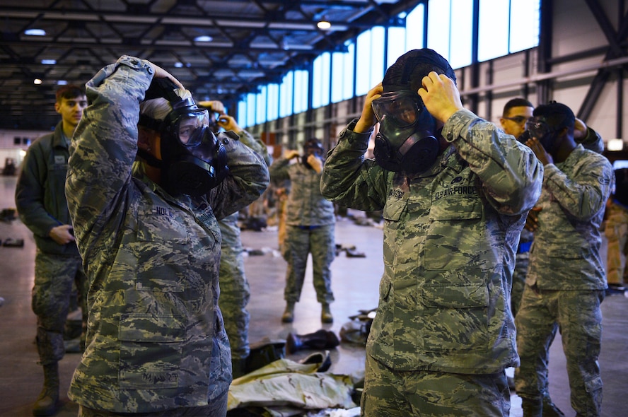 521st Air Mobility Operations Wing Airmen don gas masks during a chemical, biological, radiological, and nuclear training session on Ramstein Air Base, Germany, Feb. 16, 2018. The 721st Air Mobility Operations Group conducted a training day which included CBRN skills, self-aid buddy care, and risk management. (U.S. Air Force photo by Senior Airman Joshua Magbanua)