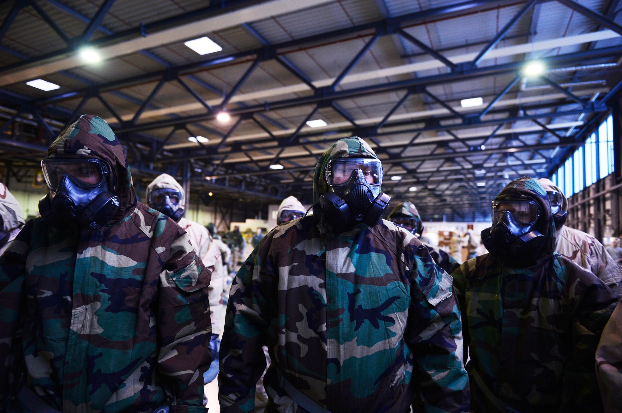 521st Air Mobility Operations Wing Airmen stand in protective gear during a chemical, biological, radiological, and nuclear training session on Ramstein Air Base, Germany, Feb. 16, 2018. The 721st Air Mobility Operations Group conducted a training day to ensure Airmen remain proficient in various warfighting skills. (U.S. Air Force photo by Senior Airman Joshua Magbanua)