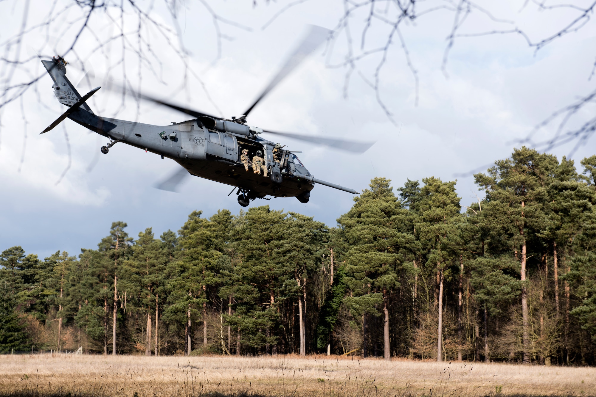 57th Rescue Squadron pararescueman depart in a 56th RQS HH-60G Pave Hawk during a training scenario for exercise Point Blank at the Stanford Training Area, England, Feb. 27. Point Blank seeks to increase coalition interoperability by providing a venue for various training opportunities in the local area. (U.S. Air Force photo/Senior Airman Malcolm Mayfield)