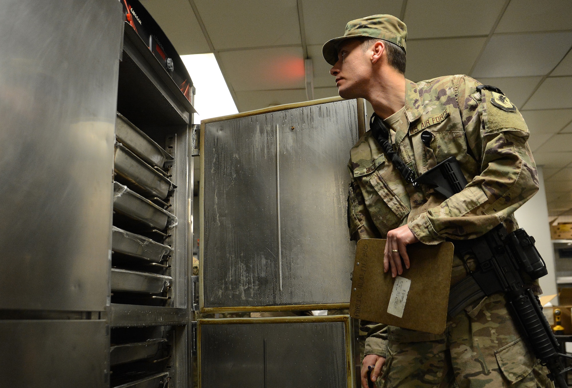 Staff Sgt. Nikola Bozic, 455th Expeditionary Medical Group public health technician, inspects a food warmer during his routine food inspection of the Grady dining facility Feb. 15, 2018 at Bagram Airfield, Afghanistan.