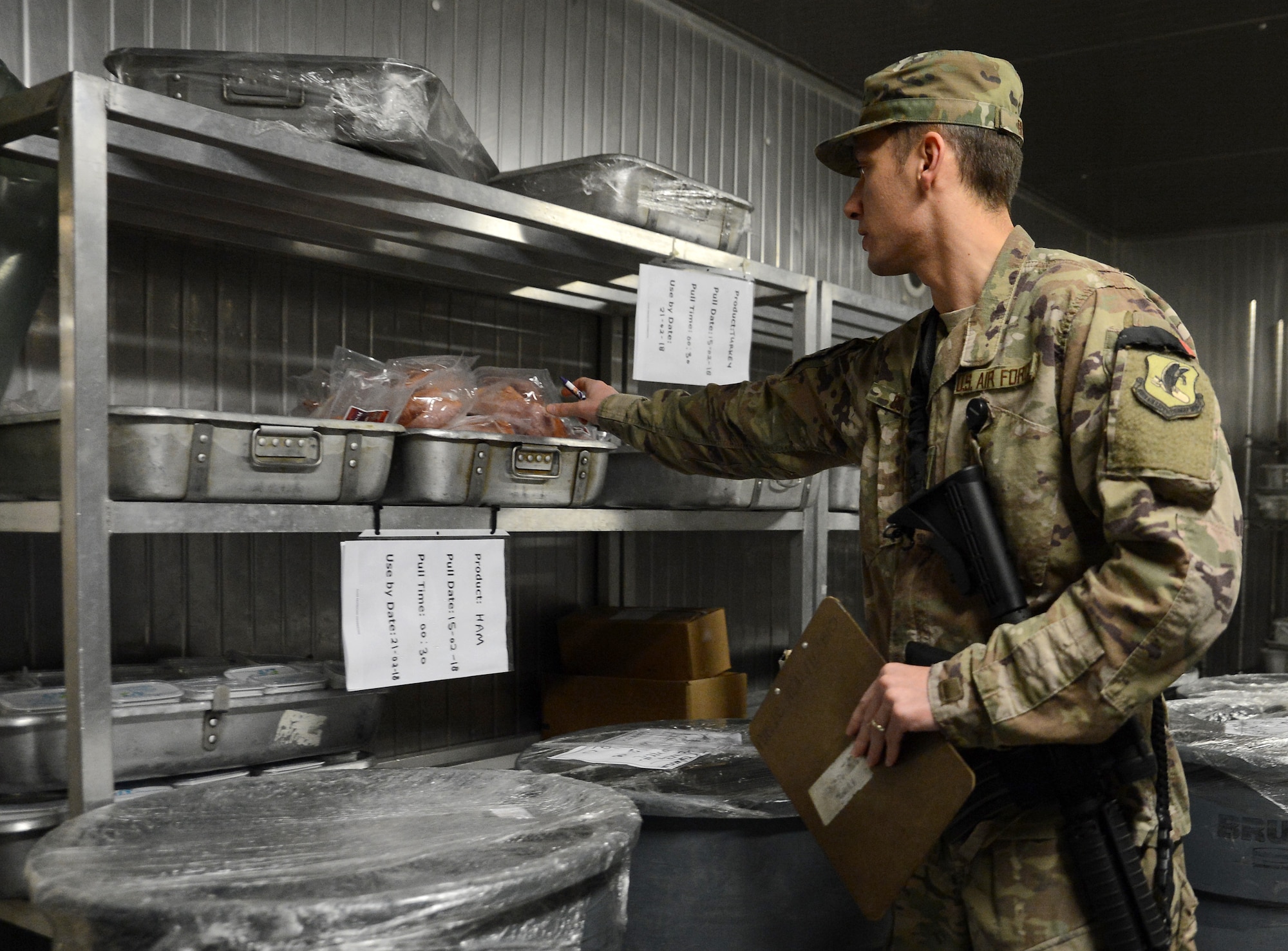 Staff Sgt. Nikola Bozic, 455th Expeditionary Medical Group public health technician, checks for expired food during his routine food inspection of the Grady dining facility Feb. 15, 2018 at Bagram Airfield, Afghanistan.