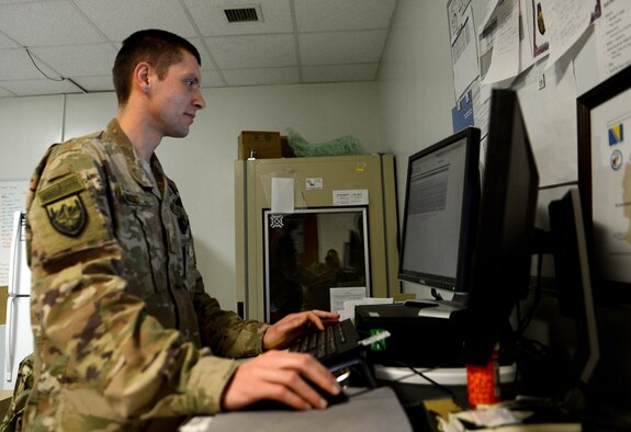 Staff Sgt. Nikola Bozic, 455th Expeditionary Medical Group public health technician, inputs data into his computer after conducting his routine food inspection of the Grady dining facility Feb. 15, 2018 at Bagram Airfield, Afghanistan.