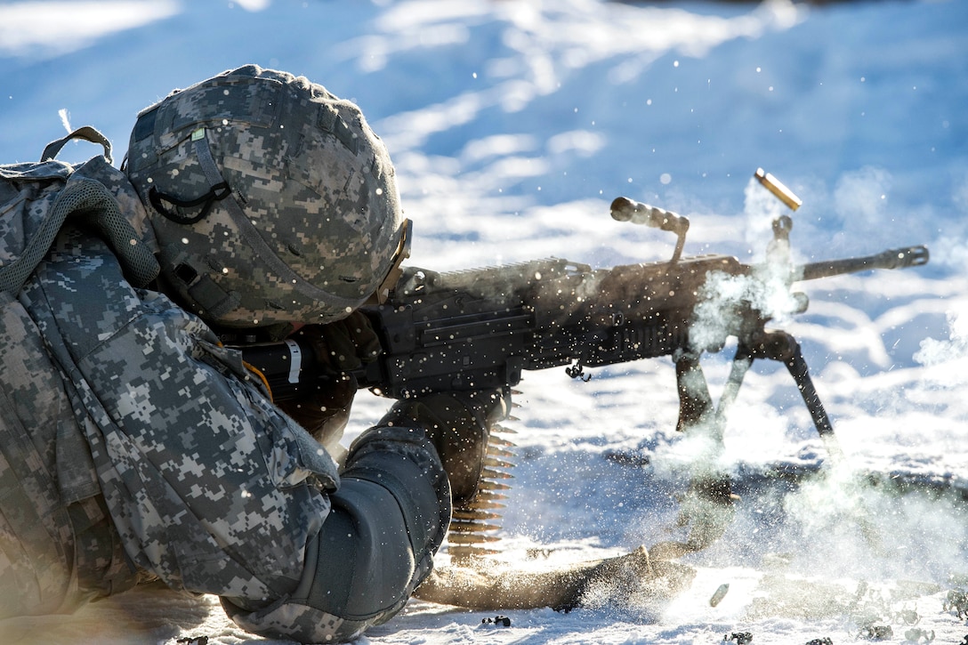 A soldier fires an M249 light machine gun during training.