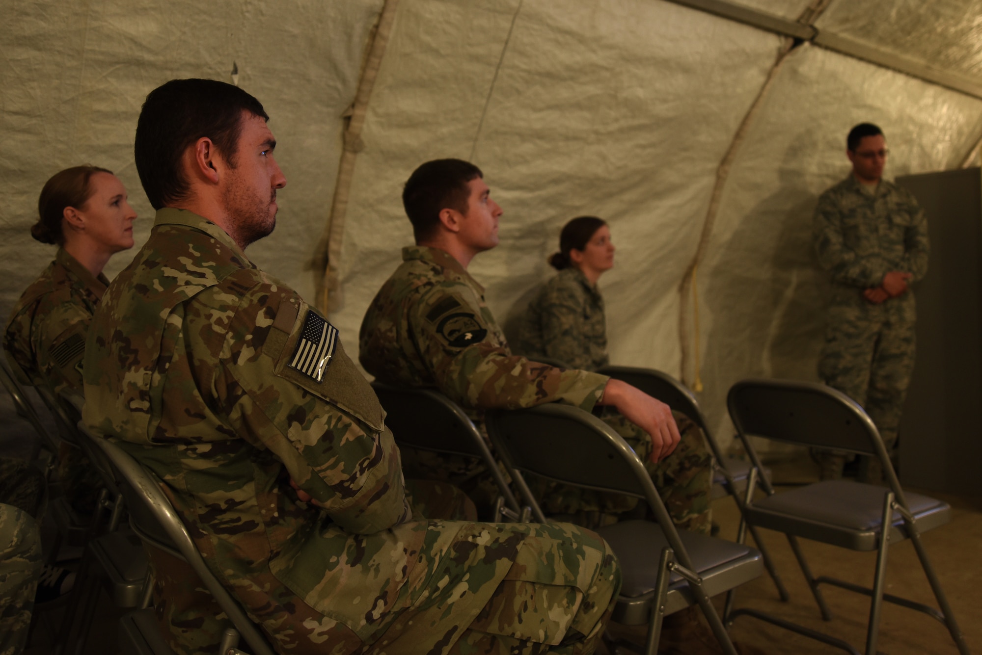 Team Shaw members gather for a briefing about the 432nd Operations Group Det. 1 during an open house at Shaw Air Force Base, S.C., Feb. 22, 2018.