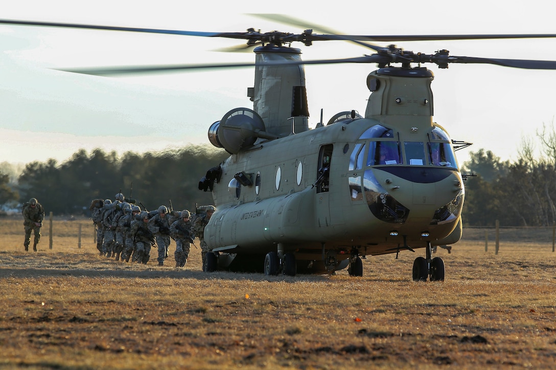 Soldiers load up onto a CH-47 Chinook helicopter.