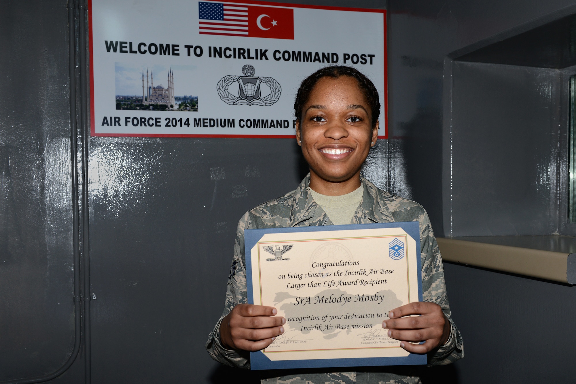 Senior Airman Melodye Mosby, 39th Air Base Wing Command Post senior emergency actions controller, accepts the deployed Larger Than Life award.