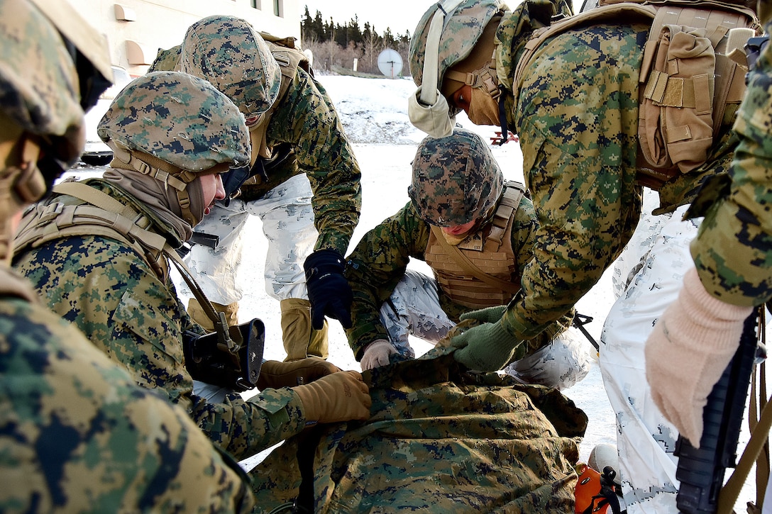 Marines practice methods for packaging and transporting a hypothermic casualty.