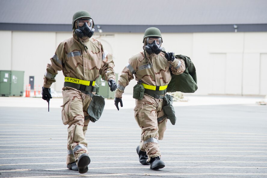 Team Dover Airmen move to a secured position during the 2018 Vengeant Eagle Exercise Feb. 22, 2018, at Dover Air Force Base, Del. The exercise included a simulated exposure to a nuclear, biological or chemical agent. (U.S. Air Force photo by Mauricio Campino)