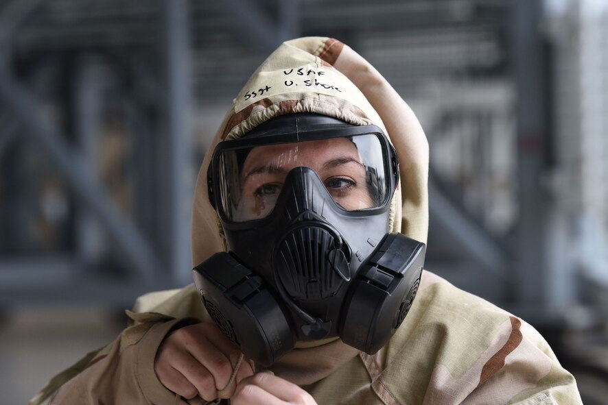 Staff Sgt. Victoria Shore, 736th Aircraft Maintenance Squadron, secures her M50 gas mask, a part of Mission Oriented Protective Posture, or MOPP gear, during the 2018 Exercise Vengeant Eagle Feb. 22, 2018. To show that full mobility is still possible, Airmen performed their jobs while wearing MOPP gear. (U.S. Air Force photo by Airman 1st Class Zoe M. Wockenfuss)