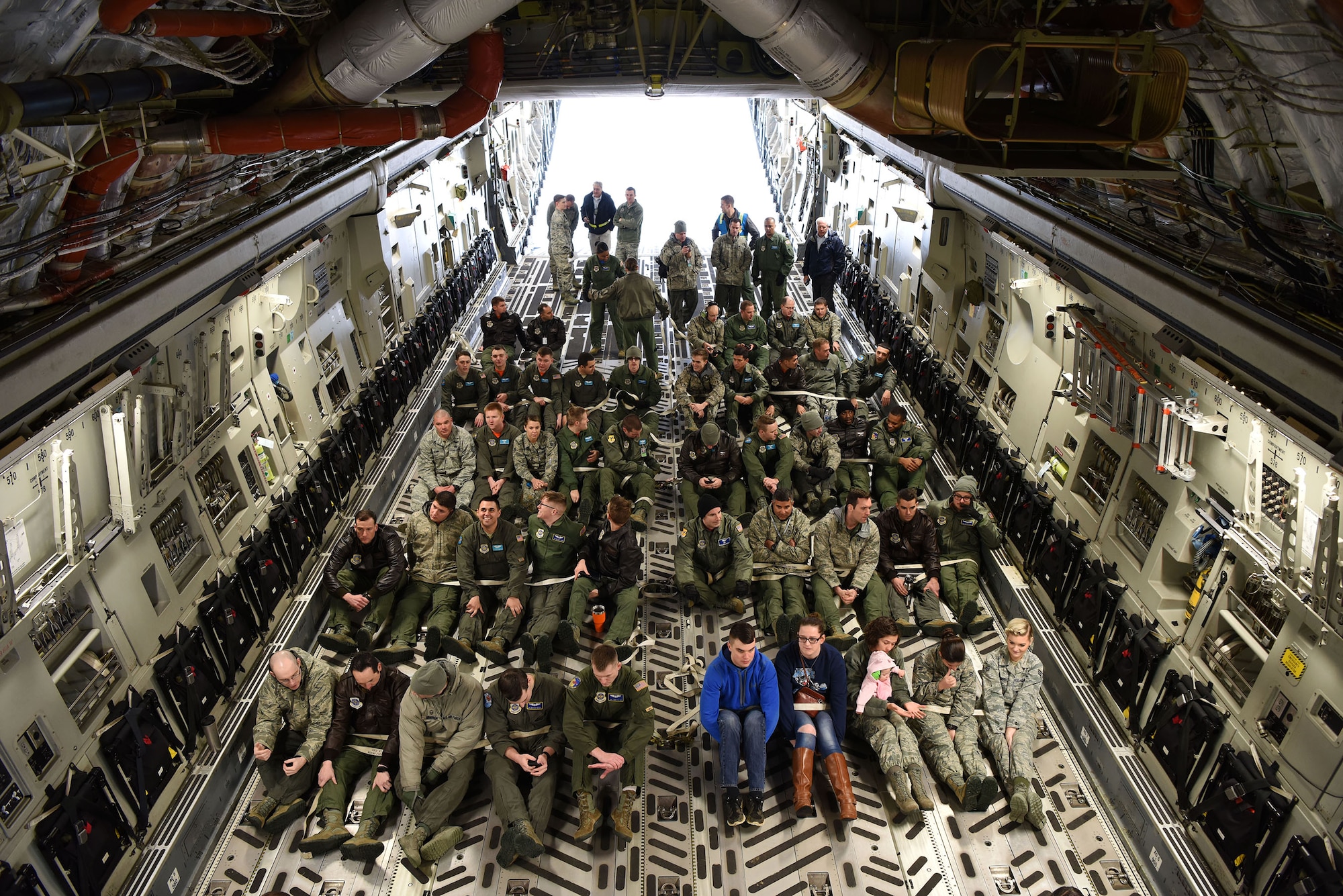 The 436th Aerial Port Squadron Passenger Terminal, the 3rd Airlift Squadron and the 9th Airlift Squadron conducted a Noncombatant Evacuation Order during a base exercise Feb. 23, 2018. Aboard a C-17 Globemaster III, crew members secure passengers in preparation for simulated evacuation during the exercise. (U.S. Air Force photo by Airman 1st Class Zoe M. Wockenfuss)