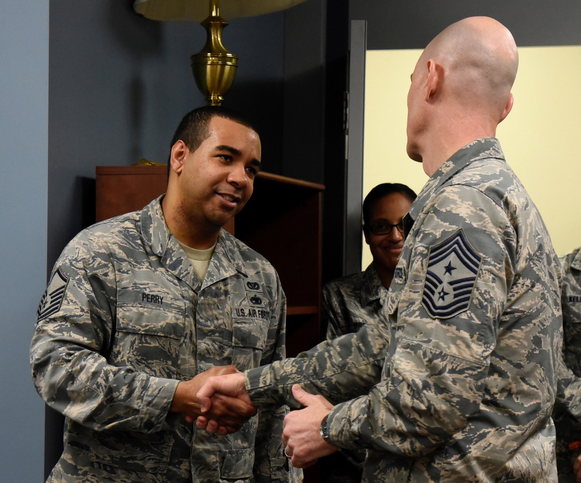 Command Chief Master Sgt. Ronald C. Anderson Jr., Command Chief Master Sergeant of the Air National Guard, coins Master Sgt. Dallas Perry, 235th Civil Engineering Flight program analyst, February 10, 2018 while touring Warfield Air National Guard Base, Middle River, Md.