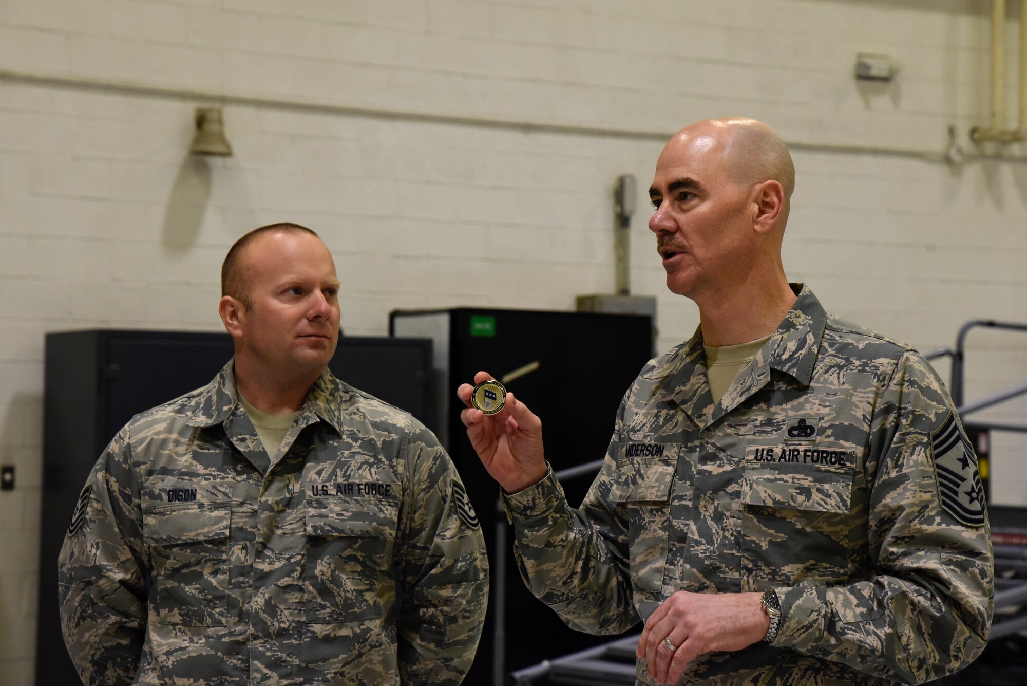 Command Chief Master Sgt. Ronald C. Anderson Jr., Command Chief Master Sergeant of the Air National Guard, gives a speech before presenting a coin to Tech. Sgt. Michael Dison, 175th Aircraft Maintenance Squadron crew chief, February 10, 2018 while touring Warfield Air National Guard Base, Middle River, Md.