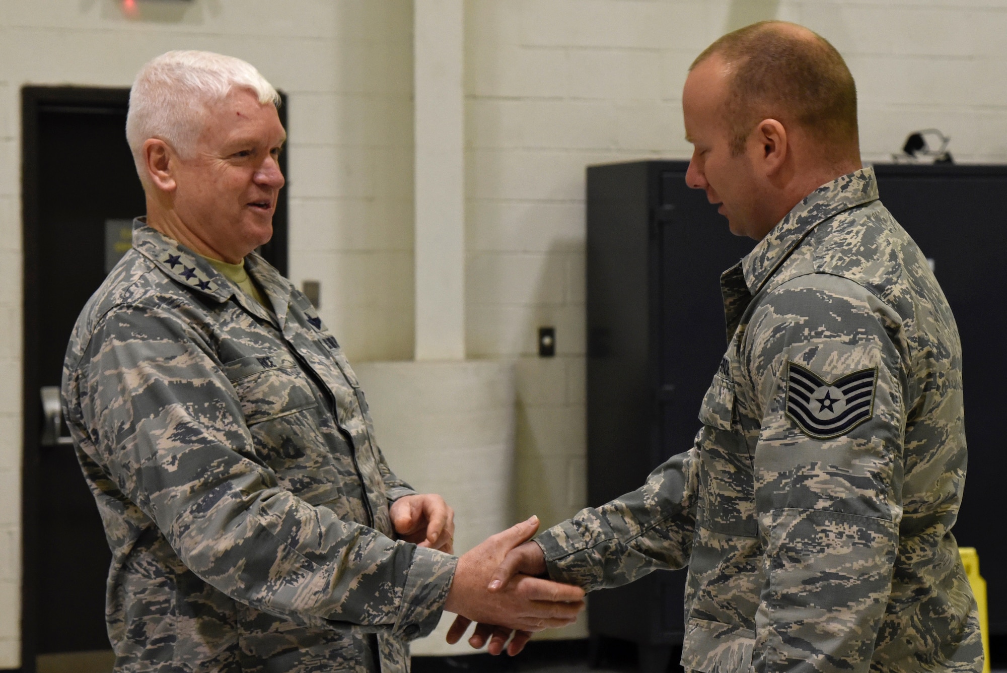 Lt. Gen. L. Scott Rice, the Director of the Air National Guard, shakes hands with Tech. Sgt. Michael Dison, 175th Aircraft Maintenance Squadron crew chief, February 10, 2018 while touring Warfield Air National Guard Base, Middle River, Md.