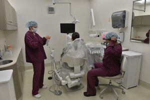 U.S. Air Force Airman 1st Class Karen Quarles, 633rd Medical Group dental assistant (left) and Major DeAndra Price-Newby, 633rd MDG general dentist (right), prepare to perform a dental exam at Joint Base Langley-Eustis, Virginia., Jan. 30, 2018.