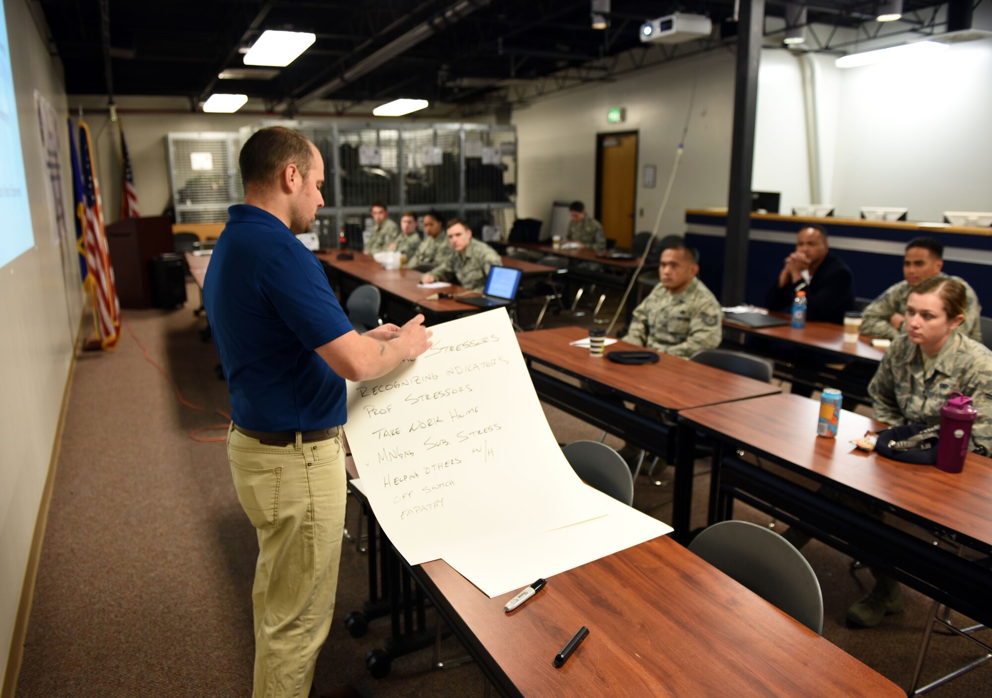 Brad Young, a training specialist with Get Safe, conducts a safety seminar with members of the 60th Security Forces Squadron Feb. 26, at Travis Air Force Base, Calif. Young's seminar aimed to teach security forces officers how to respond to situations where the victim had a mental illness, a developmental disability or is in danger of harming themselves. (U.S. Air Force photo by Airman 1st Class Christian Conrad)