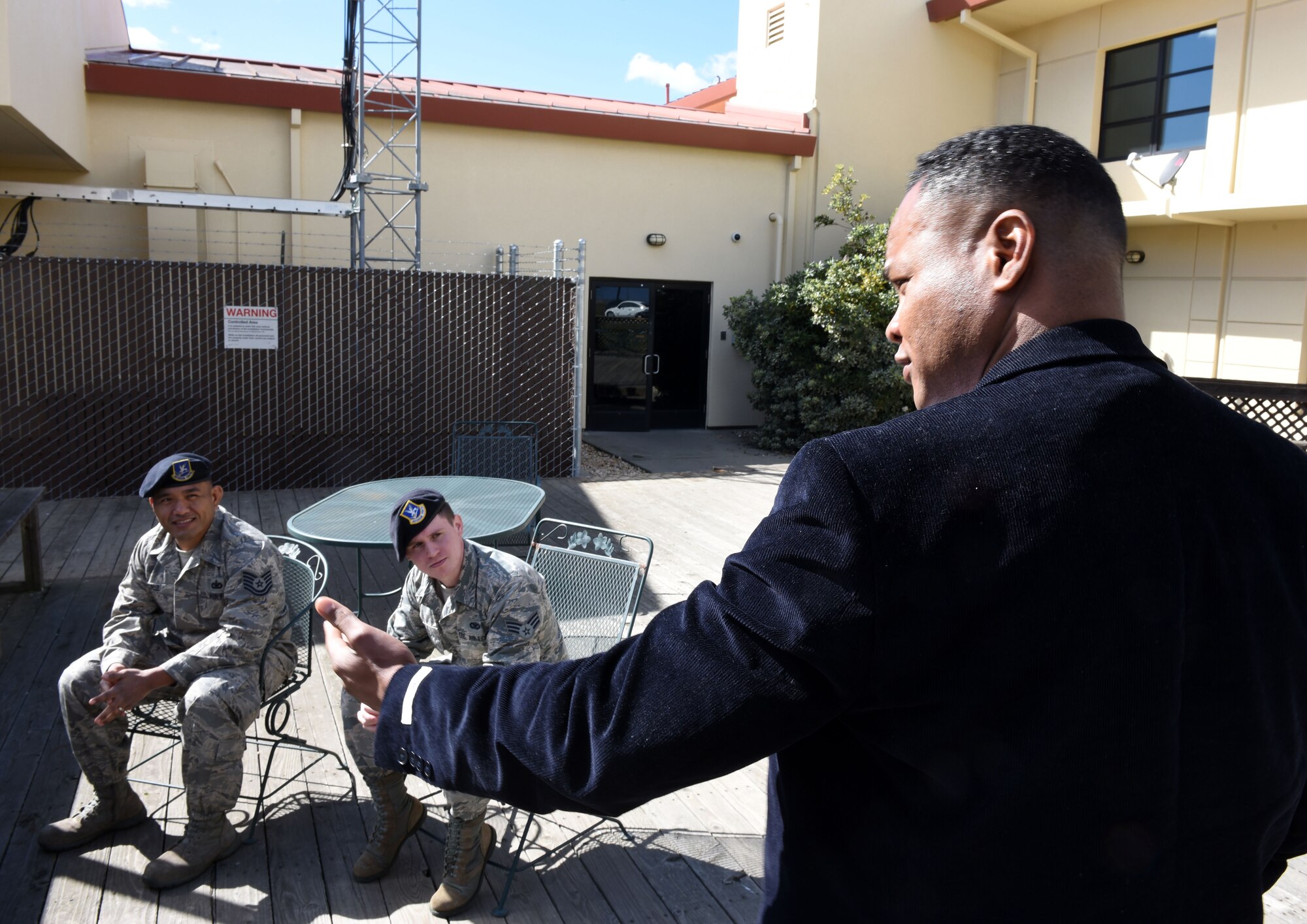 Duane Thompson, director of operations at Get Safe, gives critique to Tech Sgt. Paul Cruz, flight chief, and Senior Airman Joshua, Hill, patrolman, both with the 60th Security Forces Squadron, during a practical suicide prevention exercise Feb. 26 at Travis Air Force Base, Calif. Get Safe's training provides personal safety training to law enforcement representatives and people with developmental or intellectual disabilities. (U.S. Air Force photo by Airman 1st Class Christian Conrad)