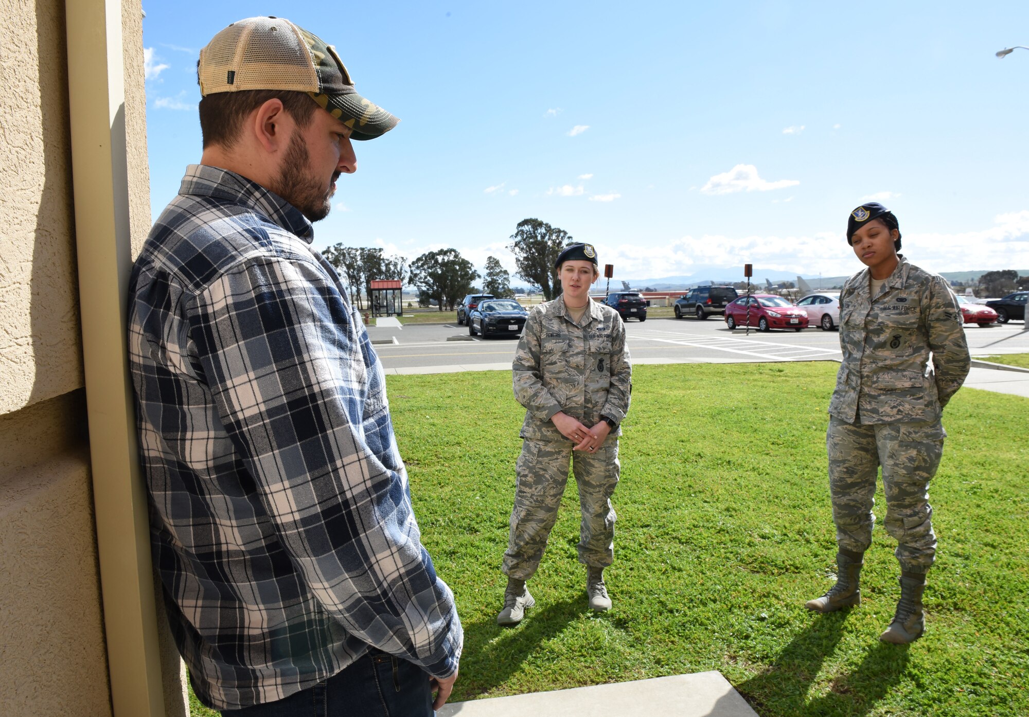Andrew Contreras, Army verteran and Get Safe volunteer, acts as a potential suicide victim during deescalation training with Airman 1st Class Ashley Powers and Airman 1st Class Kimikho Hamilton, both 60th Security Forces Squadron installation entry controllers, Feb. 26 at Travis Air Force Base, Calif. Both Powers and Hamilton received deescalation training as part of response training conducted by Get Safe. (U.S. Air Force photo by Airman 1st Class Christian Conrad)