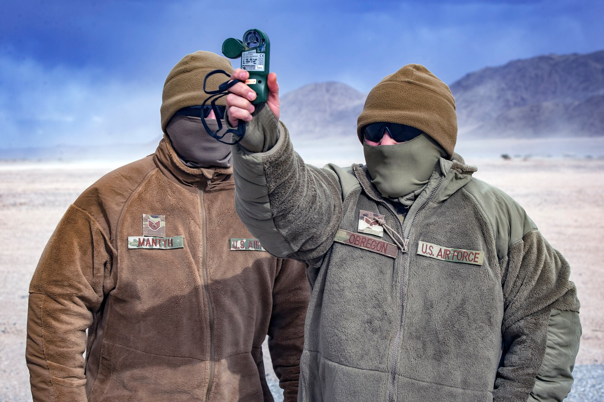 U.S. Air Force Staff Sgt. Tyler Mantyh, left, looks on as fellow 3d Weather Squadron weather forecaster Senior Airman Christopher Obregon, conducts a weather reading during pre-deployment training at Ft. Irwin, California’s National Training Center, Feb. 19, 2018. During their month-long NTC rotation, Air Force weather assets from various units within the 93d Air Ground Operations Wing advised, trained and assisted Army units to exploit weather and environmental conditions as they battled mock adversaries. As the Army’s sole weather support asset, the training maximized integration in a hostile environment to enhance interoperability and assure mission success. (U.S. Air Force photo Senior Airman Greg Nash)