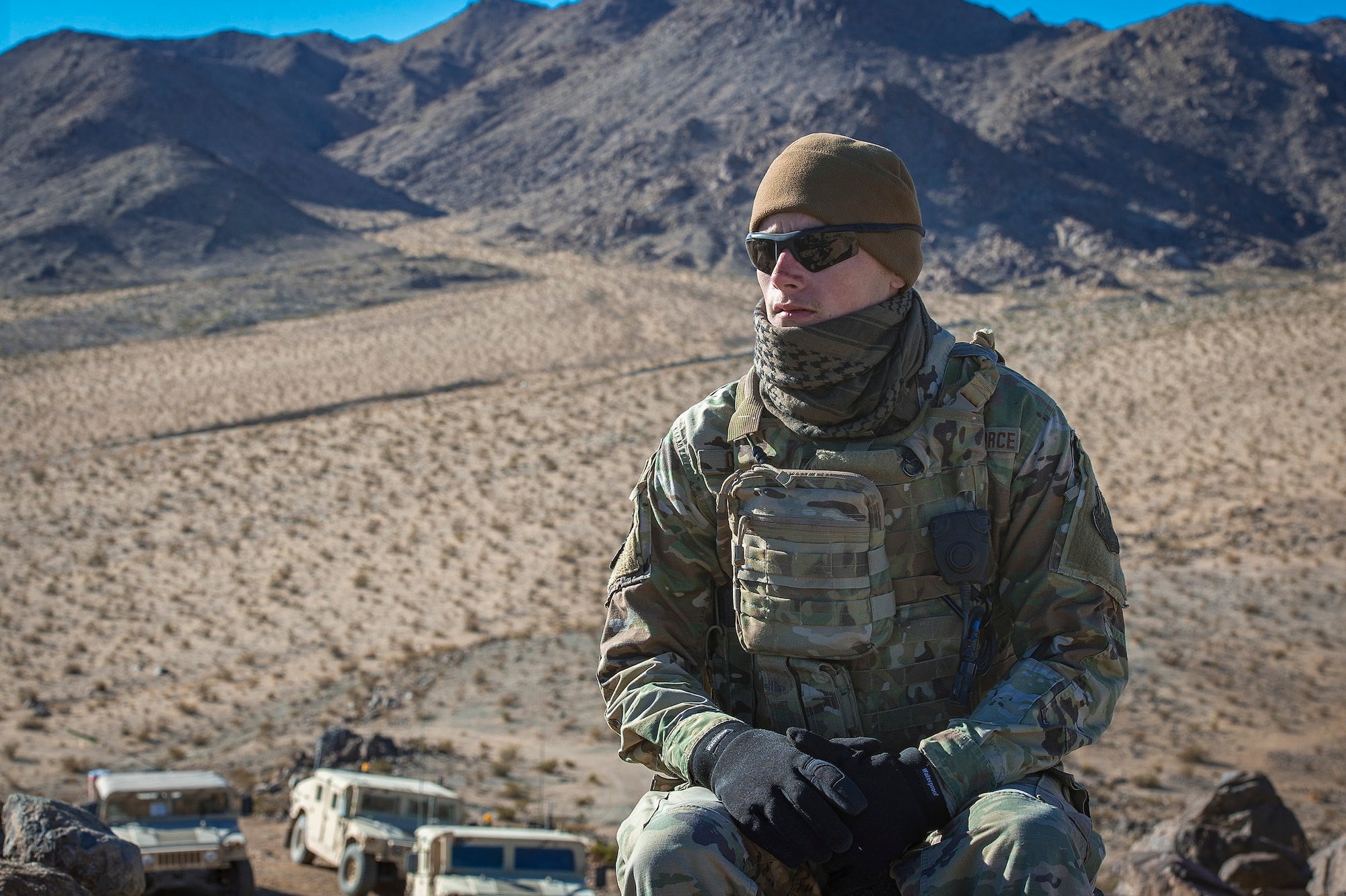 Senior Airman Dylan Olson, 11th Air Support Operations Squadron radio maintainer, embraces the cold in the Mojave Desert before helping guide F-16 Fighting Falcons through close-air support training at Ft. Irwin, Calif., during a National Training Center pre-deployment rotation, Feb. 20, 2018. Using Army support weather forecasters specialized meteorology skills, Air Force Tactical Air Control Parties helped maneuver aircraft through harsh winds in a safe manner. (U.S. Air Force photo by Senior Airman Greg Nash)