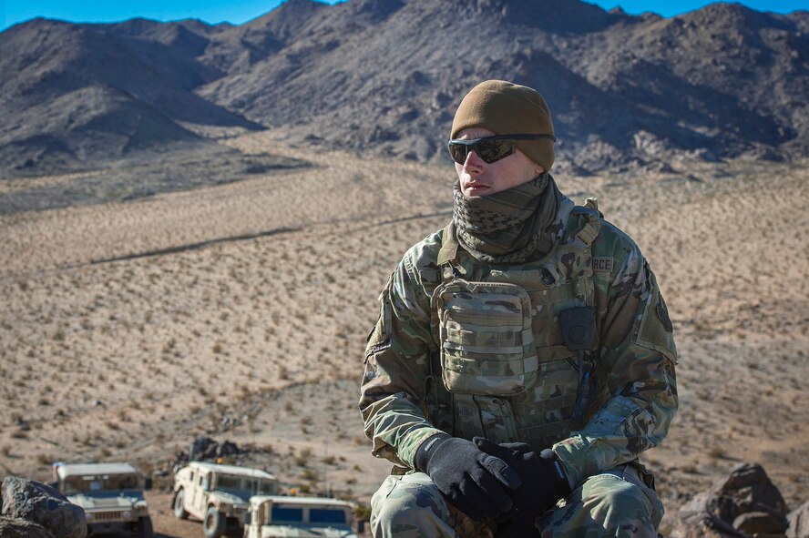 Senior Airman Dylan Olson, 11th Air Support Operations Squadron radio maintainer, embraces the cold in the Mojave Desert before helping guide F-16 Fighting Falcons through close-air support training at Ft. Irwin, Calif., during a National Training Center pre-deployment rotation, Feb. 20, 2018. Using Army support weather forecasters specialized meteorology skills, Air Force Tactical Air Control Parties helped maneuver aircraft through harsh winds in a safe manner. (U.S. Air Force photo by Senior Airman Greg Nash)