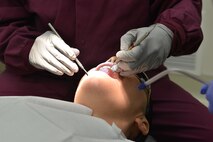 U.S. Air Force Major DeAndra Price-Newby, 633rd Medical Group general dentist (left) performs a dental exam at Joint Base Langley-Eustis, Virginia., Jan. 30, 2018.