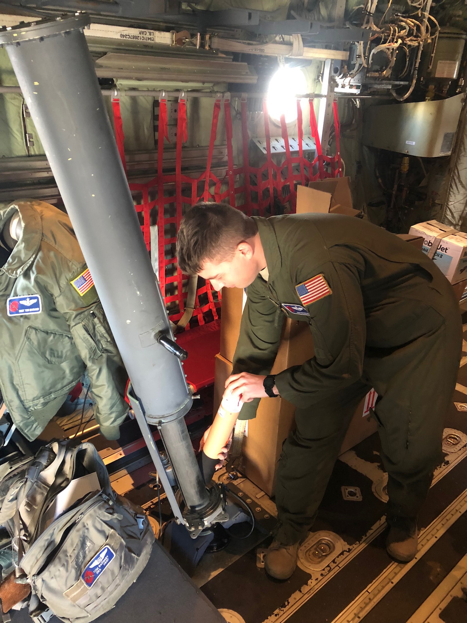 Master Sgt. Thomas Barnaby, 53rd Weather Reconnaissance Squadron loadmaster, loads a dropsonde into a dropsonde cannon aboard a WC-130J Super Hercules Aircraft Jan. 26, 2018 above the Pacific Ocean during an atmospheric river mission. (U.S. Air Force courtesy photo)